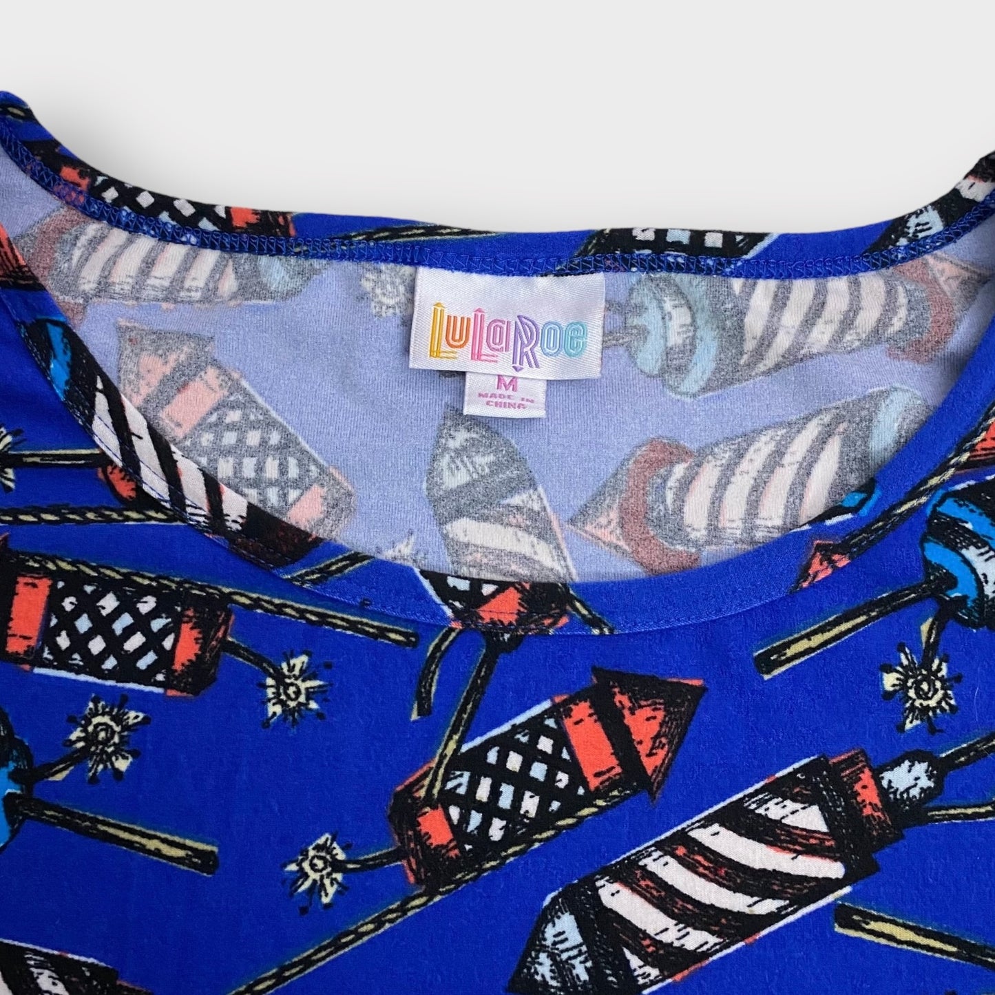 LuLaRoe S/s Irma Tunic | M (10-12) | Blue/Multicolor Rockets | NWT