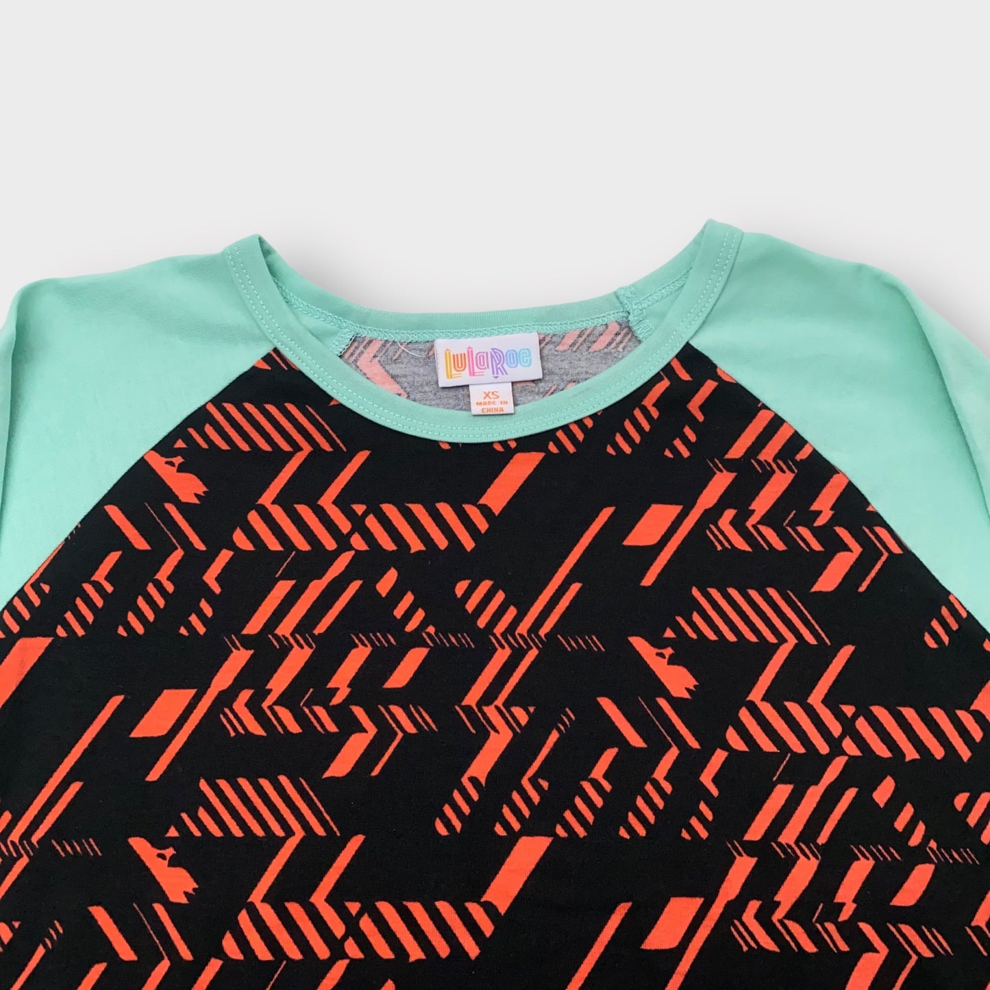 LuLaRoe Randy Raglan Tee XS (0-2) - Black/Red Geometric Abstract Print with Mint Green Sleeves - Soft Stretch Fabric